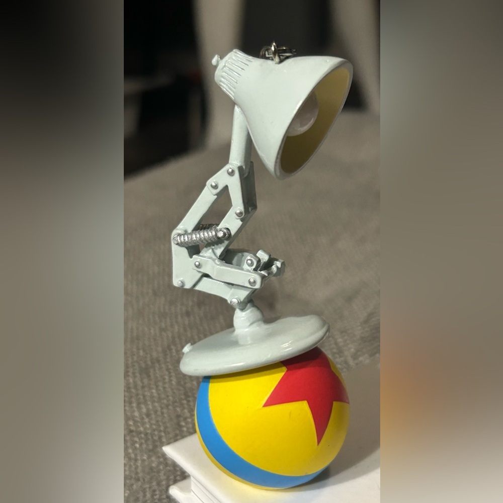 PIXAR sculpted ornament of Luxo Jr. and Ball. 
Lobster Claw Clasp
Approx. 4'' H